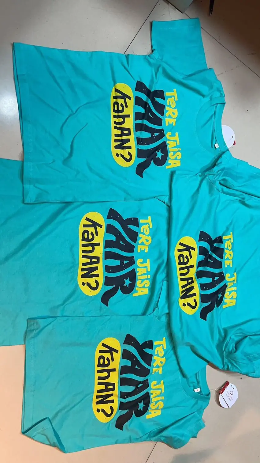 Bulk DTF printed t-shirts on teal cotton — custom direct-to-film apparel